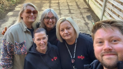 Team selfie in a garden area after cleanup