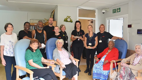 Group photo of Axis volunteers and residents in the care home