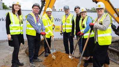 7 LQ workers stood with Fiona Fletcher-Smith holding shovels at development