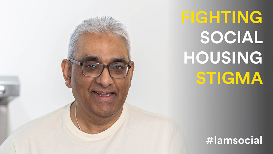 Headshot of Raj looking at the camera smiling. Raj is wearing a white top and wears square glasses. On the right of the image is text that reads: FIGHTING SOCIAL HOUSING STIGMA #iamsocial