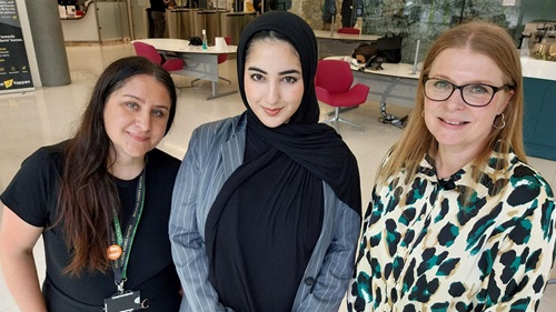 Kalee Sohanpal, L&Q Community Development Lead, Alaae Brahime, Kings College London University student, and Cat Berry, Assistant Director of Operations at Jigsaw Conferences Ltd smiling indoors; one in a hijab, one with dark hair, and one with blonde hair and glasses.