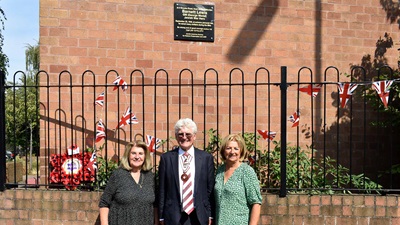 war heros family stood in front of the plaque honouring Barnett Lewis