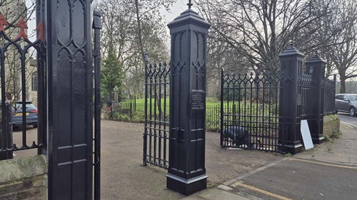 Newly repainted black cast iron gates at St Dunstan's Church entrance, featuring Gothic-style detailing.