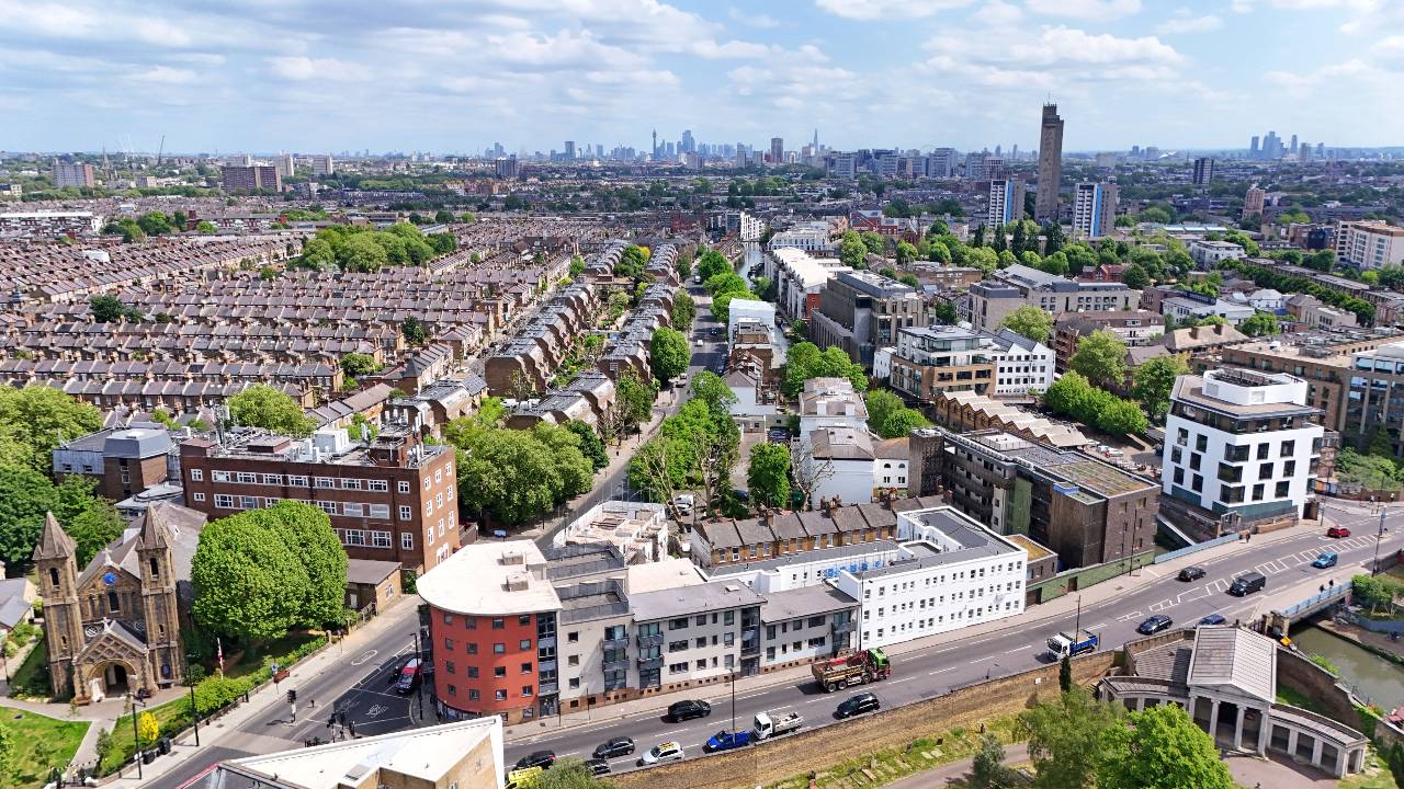 Aerial view of an urban area with a large white building at the centre
