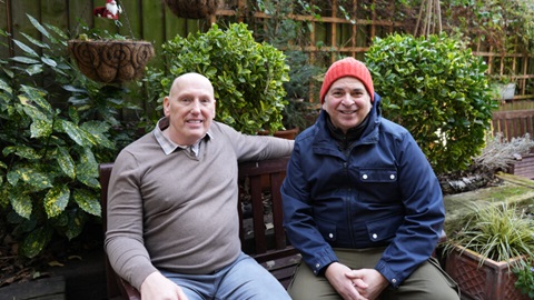 Neighbourhood Champion, Paul Moore and his partner Allan Wilson sat on a garden bench