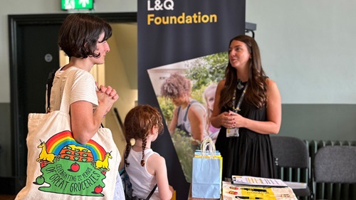 L&Q colleague at an L&Q Foundation stand speaking to two members of public