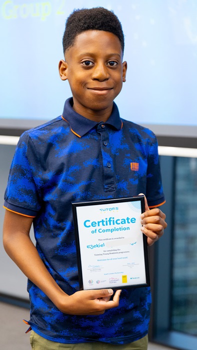 Portrait of Ezekiel stood holding a certificate