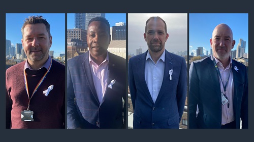 Matt Foreman, David Lewis, Steve Moseley and Tom Nicholls stood outside wearing white ribbons on their outfits