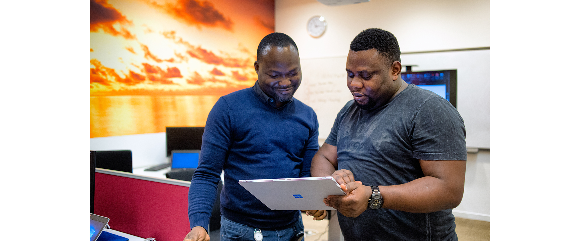 Two IT employees looking at computer