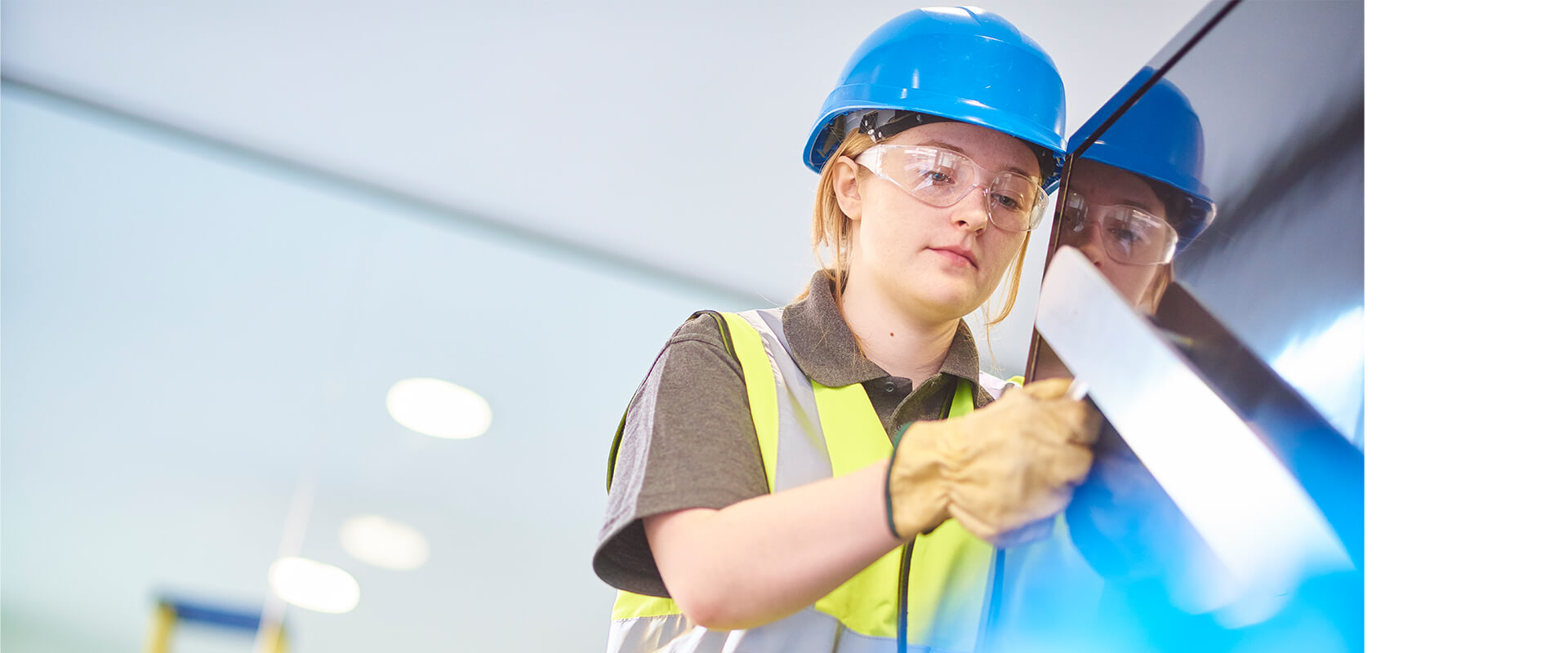Young female construction worker on site