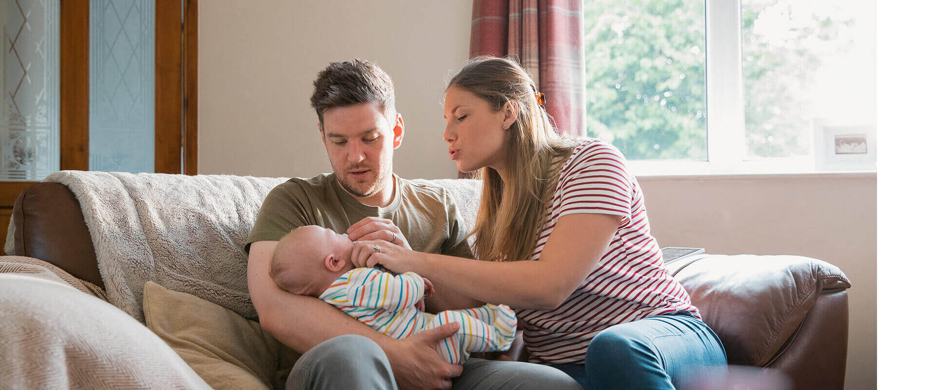 Couple smiling at their baby