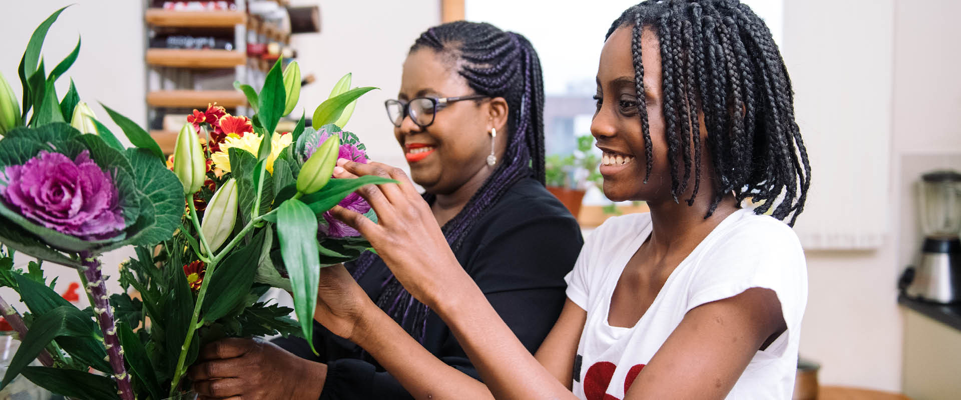 Mother and daughter arranging flowers
