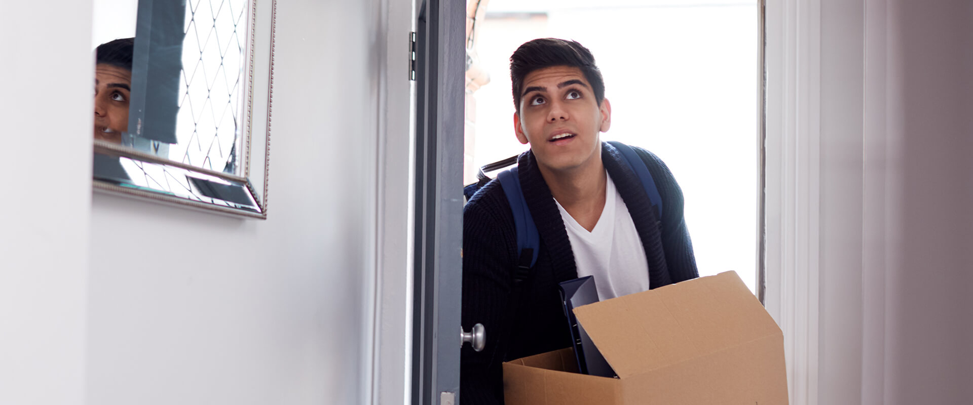 Man walking through door with box