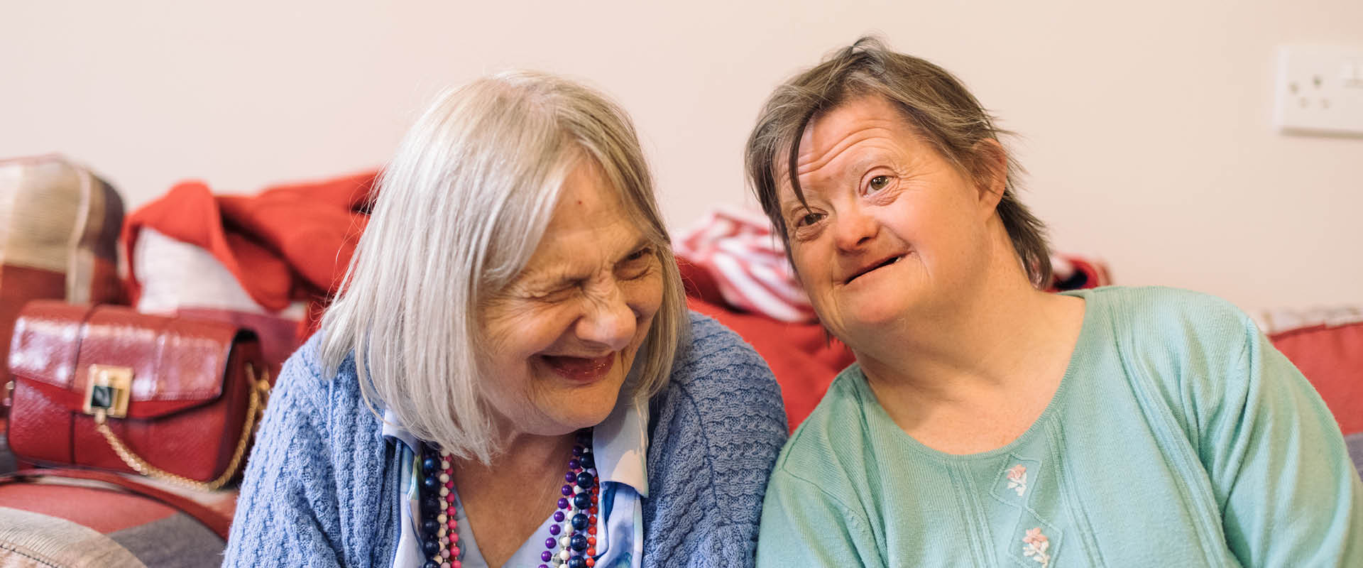 Two L and Q Living residents sat laughing and smiling