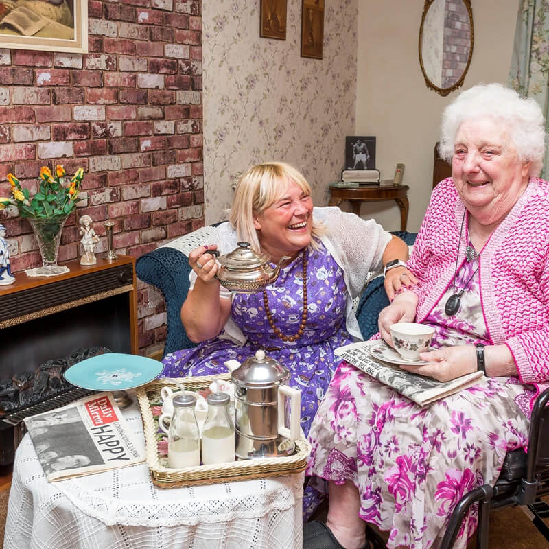 Two elderly women laughing