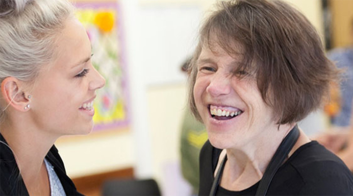 Two women smiling at each other