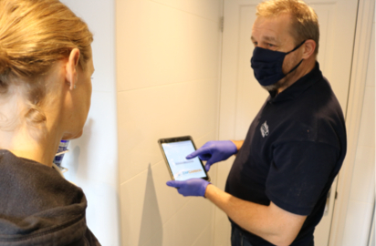 A man showing a woman something on a tablet