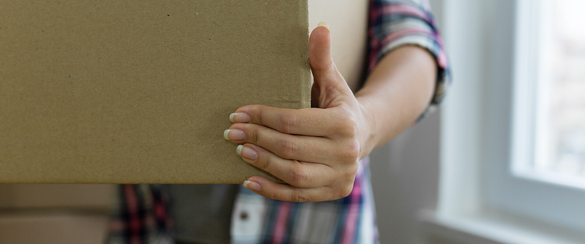 Woman carrying a cardboard box