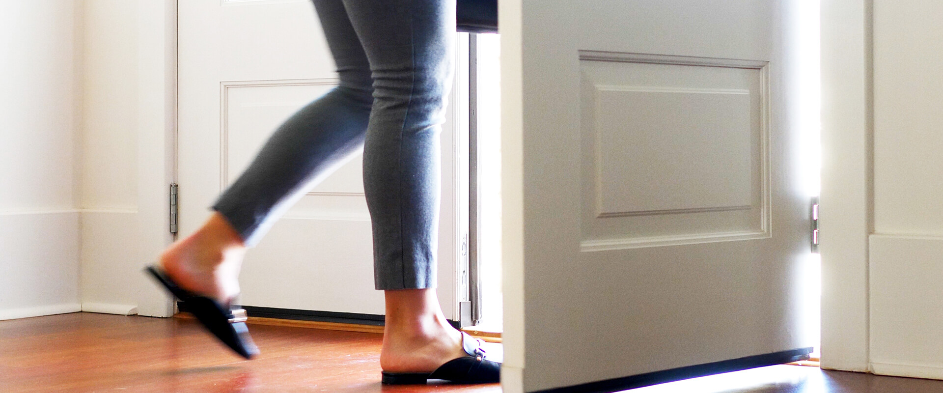 Woman walking through a doorway